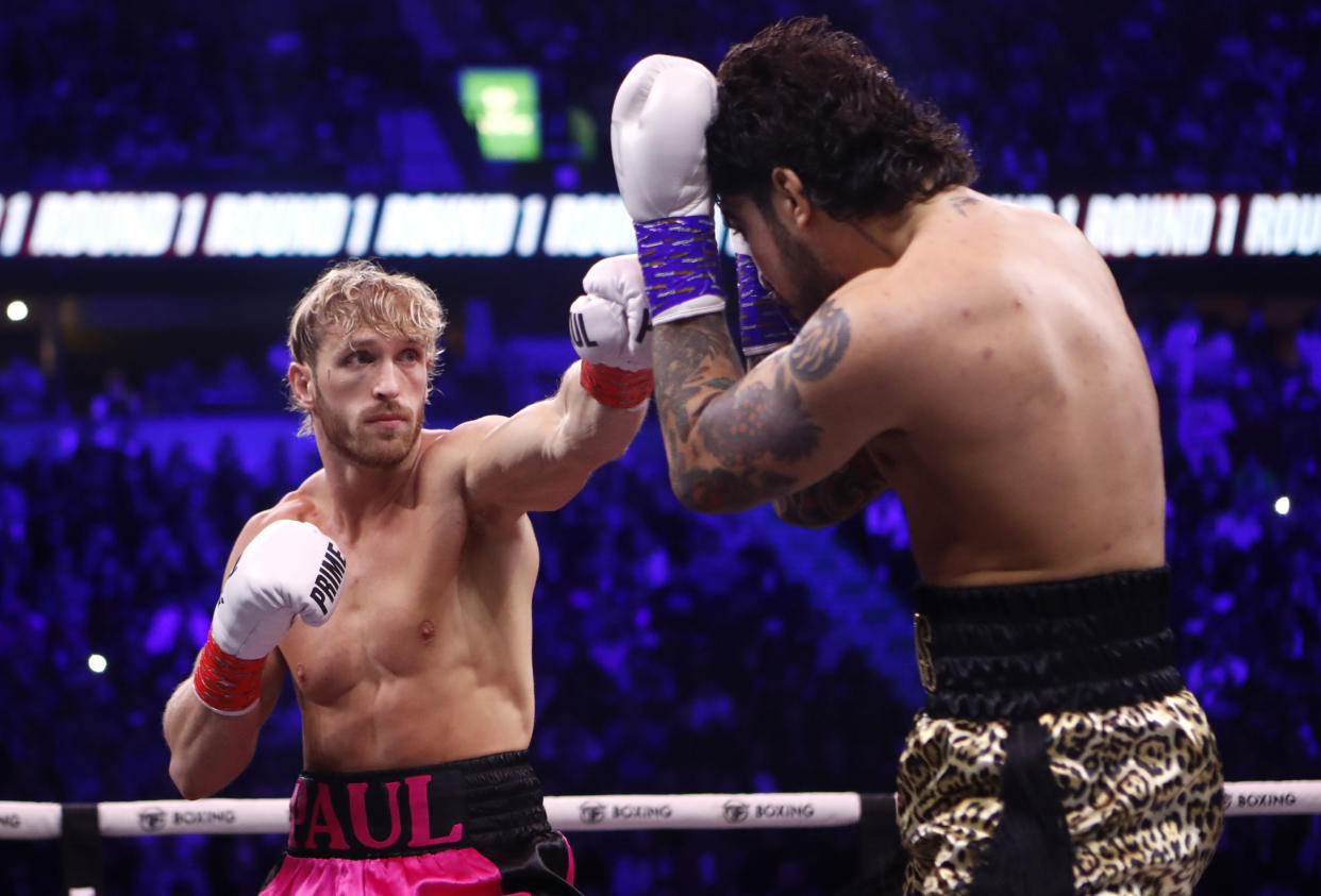 Logan Paul, left, battles against Dillon Danis during a boxing match at the AO Arena, Saturday Oct. 14, 2023, in Manchester, England. (Will Markland/PA via AP)