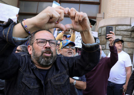 Supporters of Venezuelan opposition leader Juan Guaido celebrate and cheer for U.S. law enforcement officers as police and U.S. Secret Service arrested and removed the remaining activists sympathetic to embattled President Nicolas Maduro who had been part of a multi-week occupation of Venezuela's embassy to the United States in Washington, U.S., May 16, 2019. REUTERS/Jonathan Ernst