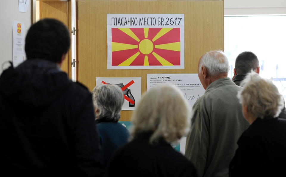 People enter a polling station to vote for the presidential elections in Skopje, Macedonia, on Sunday, April 13, 2014. Macedonia votes on the fifth presidential elections since the country's independence. (AP Photo/Boris Grdanoski)