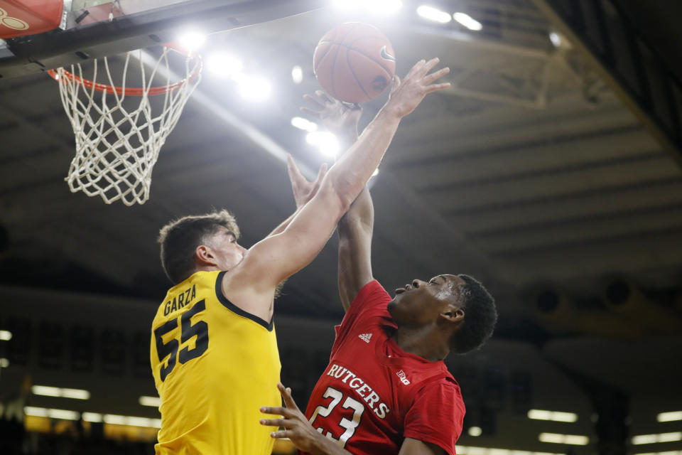 Rutgers guard Montez Mathis (23) is fouled by Iowa center Luka Garza (55) while driving to the basket during the first half of an NCAA college basketball game, Wednesday, Jan. 22, 2020, in Iowa City, Iowa. (AP Photo/Charlie Neibergall)