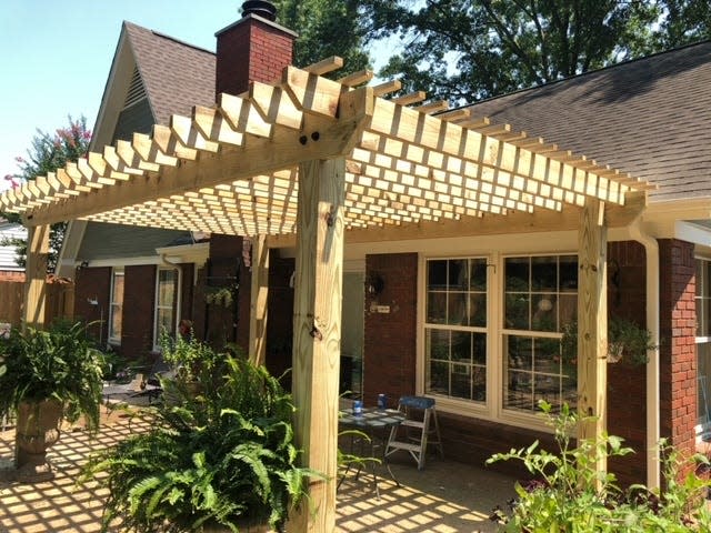 Adding a wood pergola to a porch can enhance its beauty.