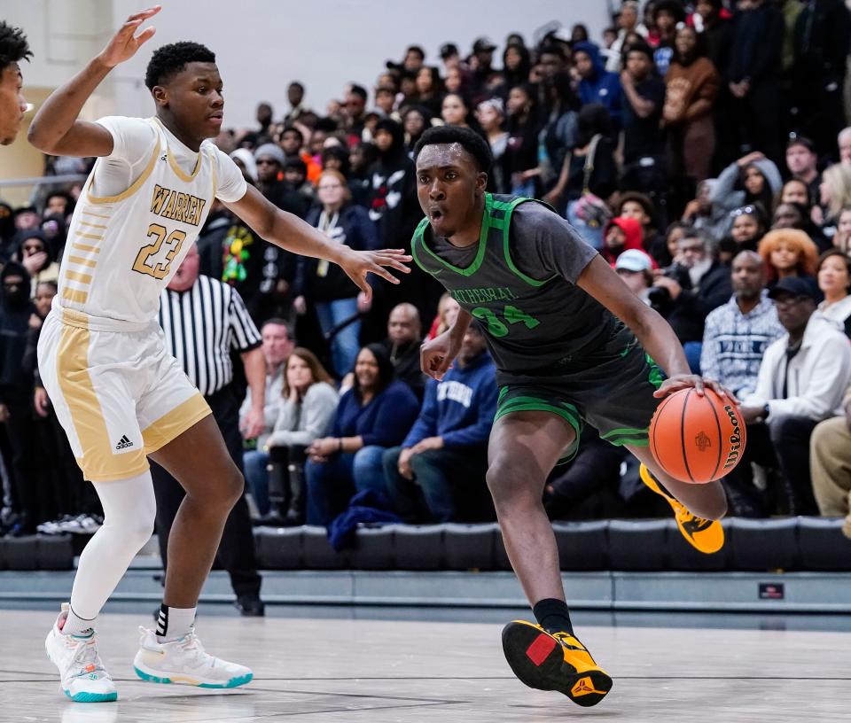 Cathedral Fighting Irish Xavier Booker (34) rushes up the court against Warren Central's Jevon Guess (23) on Friday, March 3, 2023 at Warren Central High School in Indianapolis. The Cathedral Fighting Irish defeated Warren Central, 64-61. 