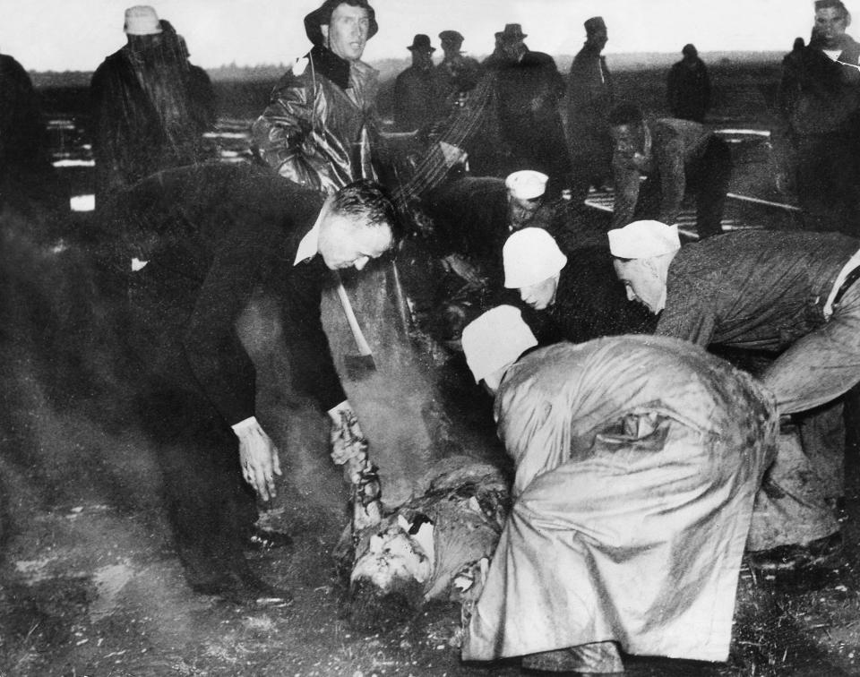 <p>Rescuers on the scene of the Hindenberg explosion in Lakehurst, New Jersey on May 6, 1937. (Heinrich Hoffmann/ullstein bild via Getty Images) </p>