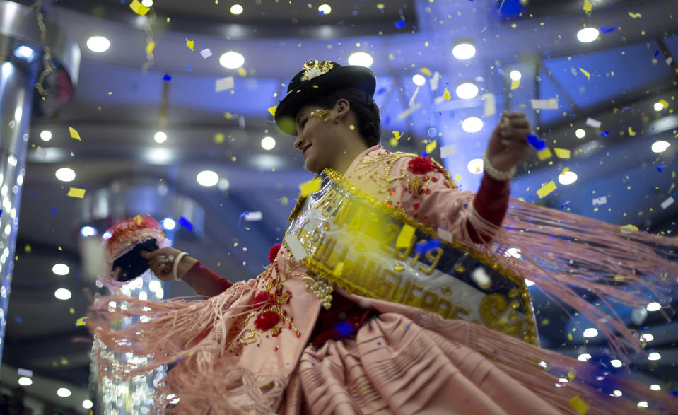 A woman competes in the Queen of the Great Power contest, in La Paz, Bolivia, Friday, May 24, 2019. The largest religious festival in the Andes choses its queen in a tight contest to head the Festival of the Lord Jesus of the Great Power, mobilizing thousands of dancers and more than 4,000 musicians into the streets of La Paz. (AP Photo/Juan Karita)