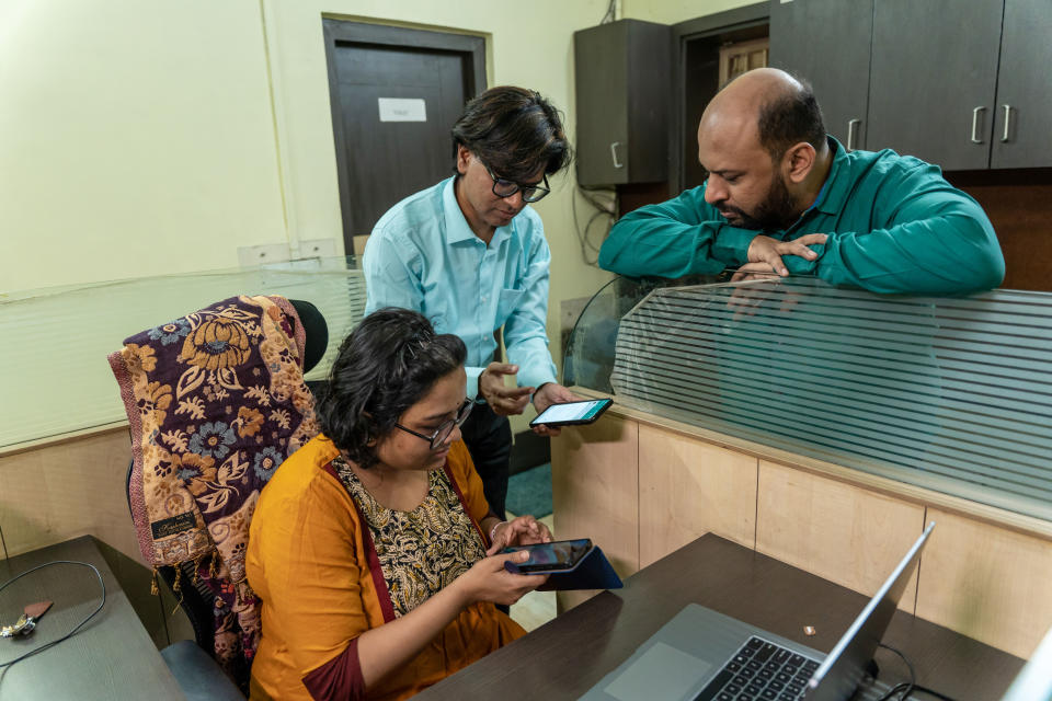 Alt News founders Mohammed Zubair and Pratik Sinha discuss the news with Mahaprajna Nayek, a research associate, in the Kolkata bureau. (Jit Chattopadhyay for NBC News)