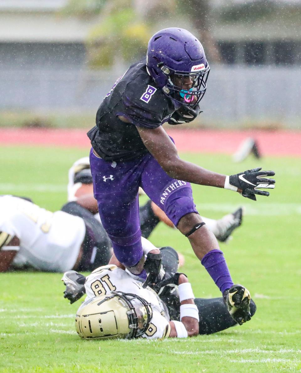 Cypress Lake's Cedric Jenkins breaks the tackle by Gateway's Tyler McClendon to go on and score. The continuation of Gateway at Cypress Lake High football which started play on Friday.  Canceled because of weather, they resumed play Monday evening, August 29, 2022, at Cypress Lake.