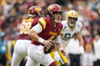 Washington Commanders quarterback Taylor Heinicke looks to pass during the first half of an NFL football game against the Green Bay Packers, Sunday, Oct. 23, 2022, in Landover, Md. (AP Photo/Patrick Semansky)