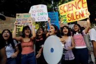 Students and activists hold placards with messages as they participate in a Global Climate Strike rally in New Delhi