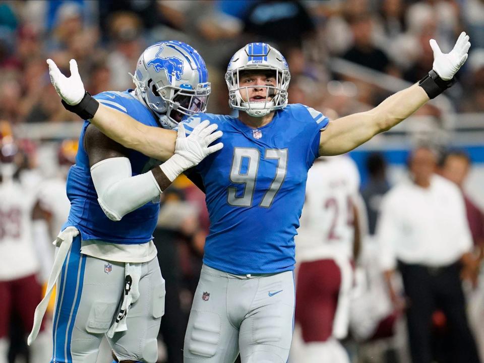 Aidan Hutchinson celebrates a sack against the Washington Commanders.