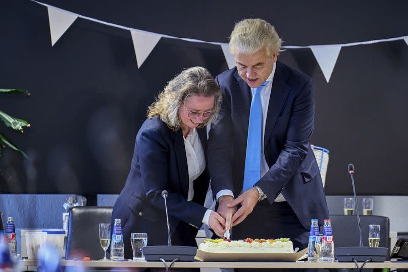 Far-right Party for Freedom leader Geert Wilders, right, cuts a cake with Fleur Agema in The Hague, 23 November 2023