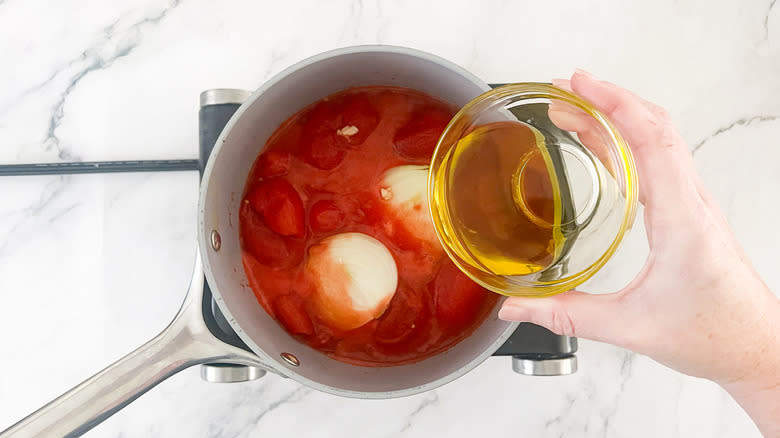 oil pouring into saucepan