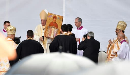 Pope Francis, seen holding an icon, said the beatified Catholic bishops, victims of political oppression, were "shepherds, martyrs of faith" whose gifts to the Romanian people in the early days of Communist rule were "freedom and mercy"