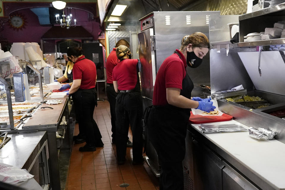 Employees work at a restaurant in Chicago, Thursday, March 23, 2023. On Friday, the U.S. government issues the March jobs report. (AP Photo/Nam Y. Huh)