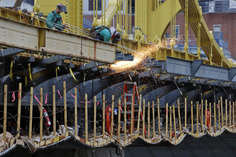 FILE - In this May 6, 2020, file photo a worker welds on the Ninth Street bridge in Pittsburgh. Looking beyond the $1.9 trillion COVID relief bill, President Joe Biden and lawmakers are laying the groundwork for another of his top legislative priorities — a long-sought boost to the nation's roads, bridges and other infrastructure that could meet GOP resistance to a hefty price tag. (AP Photo/Gene J. Puskar, File)