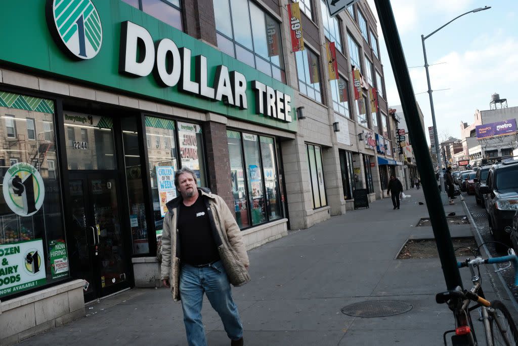 man walks pass dollar tree