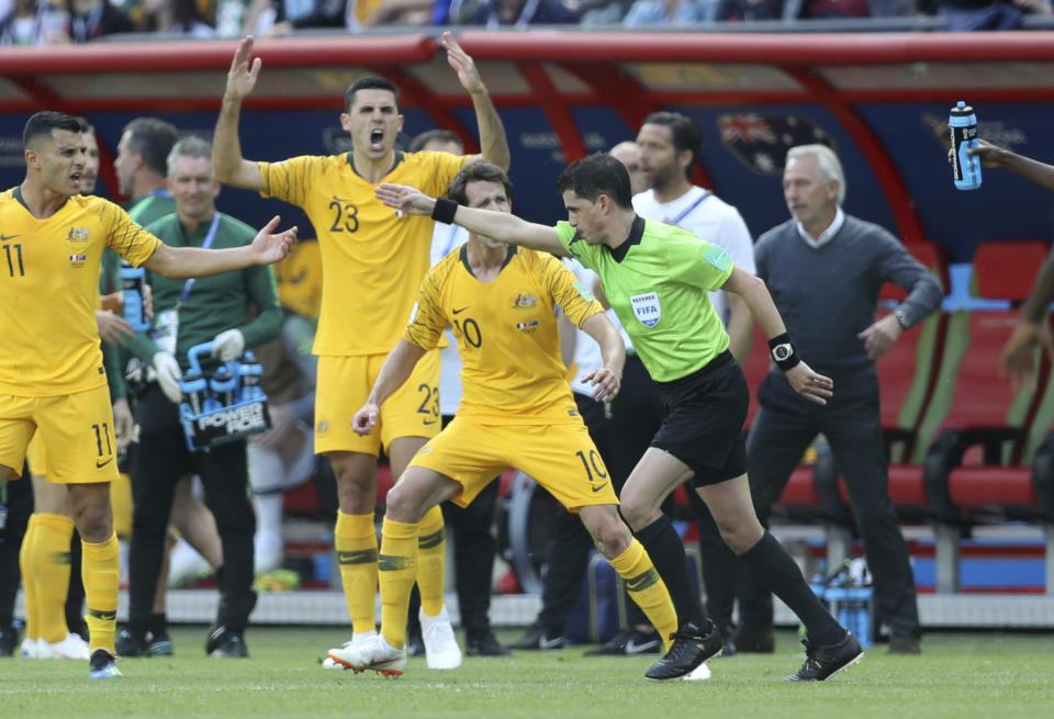 Australian players protest as referee Andres Cunha from Uruguay decides on penalty after consulting with the VAR during the group C match between France and Australia at the 2018 soccer World Cup in the Kazan Arena in Kazan, Russia, Saturday, June 16, 2018. (AP Photo/David Vincent)