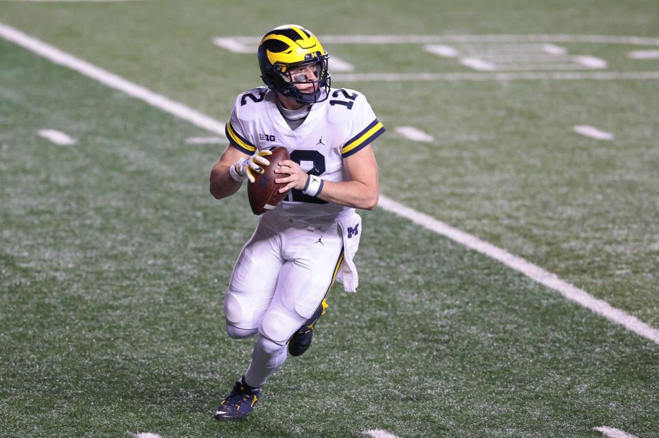 Michigan Wolverines quarterback Cade McNamara (12) rolls out during the third quarter against the Rutgers Scarlet Knights Nov. 21, 2020, at SHI Stadium.