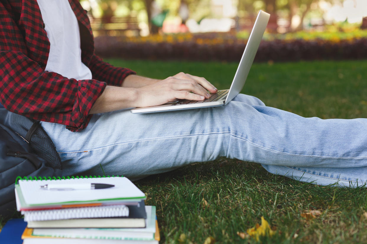 Teenage boy studying climate change sitting outside. (Getty Images)