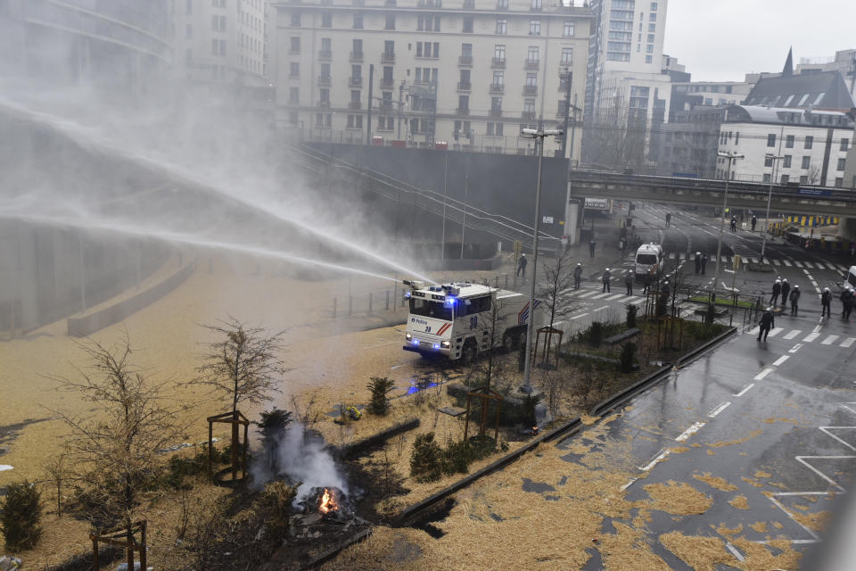 Police spray a water canon during a farmers demonstration in the European Quarter outside a meeting of EU agriculture ministers in Brussels, Monday, Feb. 26, 2024. European Union agriculture ministers meet in Brussels Monday to discuss rapid and structural responses to the crisis situation facing the agricultural sector. (AP Photo/Harry Nakos)