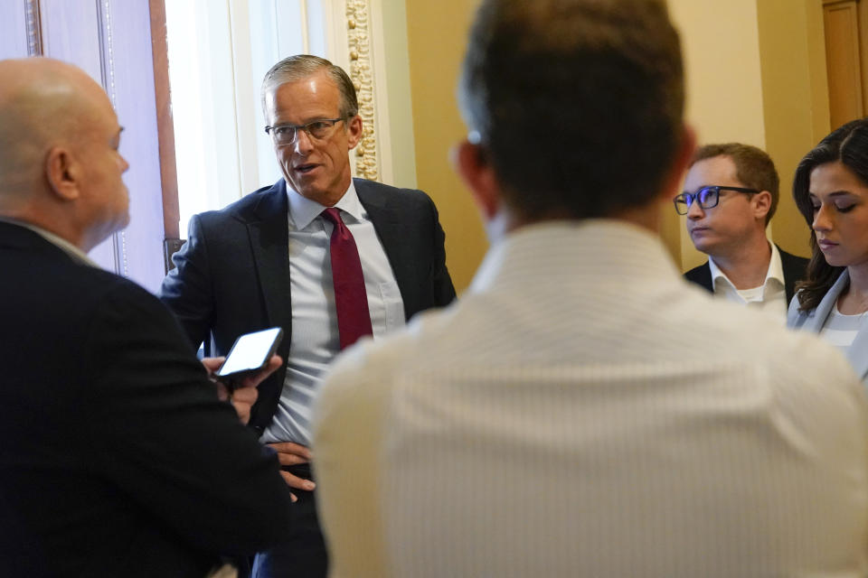 Senate Republican Whip John Thune, R-S.D., second from left, speaks with reporters outside his office on Capitol Hill in Washington, Saturday, Aug. 6, 2022. (AP Photo/Patrick Semansky)