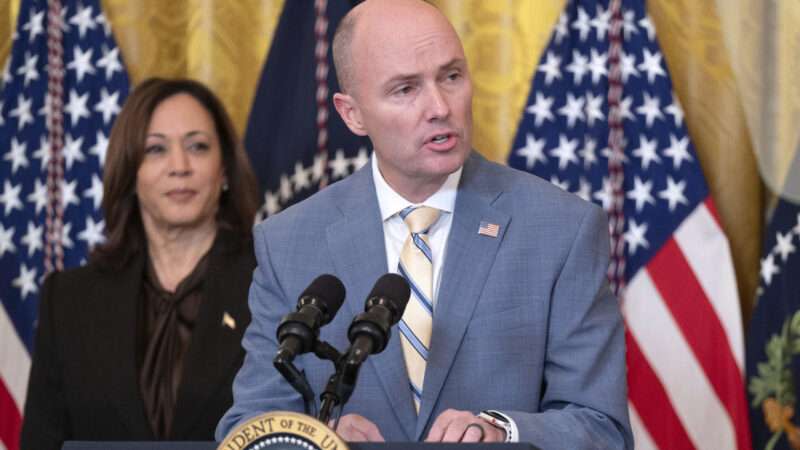 Utah Gov. Spencer Cox speaking at the White House, addressing a meeting of the National Governors Association, as Vice President Kamala Harris looks on.