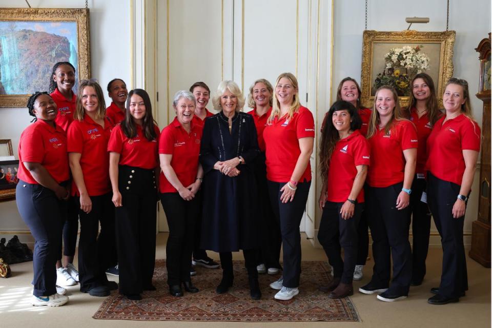 Queen Camilla with crew members as she hosts a reception for the 'Maiden' yachting crew, at Clarence House in London <i>(Image: PA)</i>