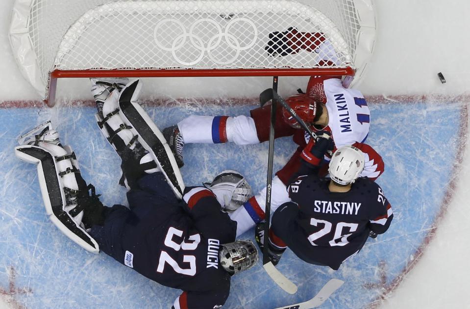 Team USA's goalie Jonathan Quick (32) makes a save on Russia's Yevgeni Malkin (R) as Team USA's Paul Stastny looks on during the first period of their men's preliminary round ice hockey game at the Sochi 2014 Winter Olympic Games February 15, 2014. REUTERS/Jim Young (RUSSIA - Tags: SPORT ICE HOCKEY OLYMPICS)