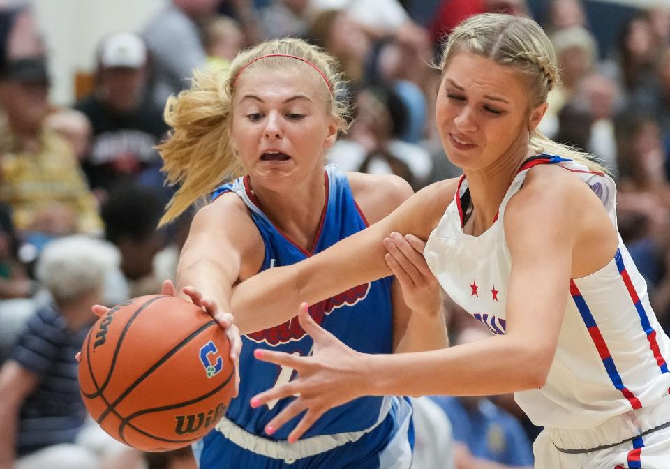 Junior All-Star Adrianne Tolen (14) and Indiana All-Star Saige Stahl (12) wrestle for the ball Wednesday, June 7, 2023, during the Indiana All-Stars vs. Juniors girls game at Cathedral High School in Indianapolis. 