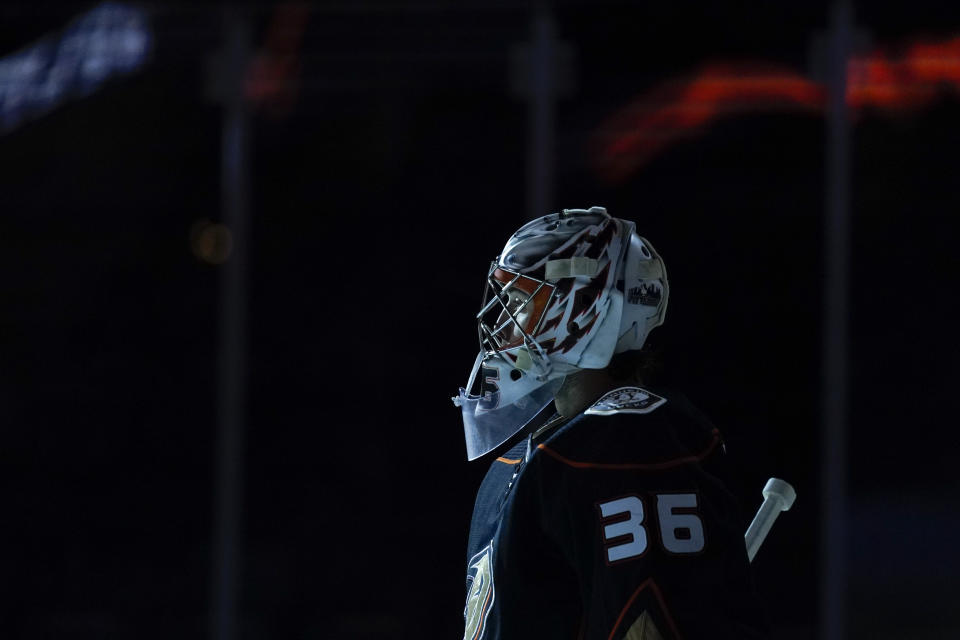 Anaheim Ducks goaltender John Gibson (36) watches as players are introduced before an NHL hockey game against the St. Louis Blues Sunday, Jan. 31, 2021, in Anaheim, Calif. (AP Photo/Ashley Landis)