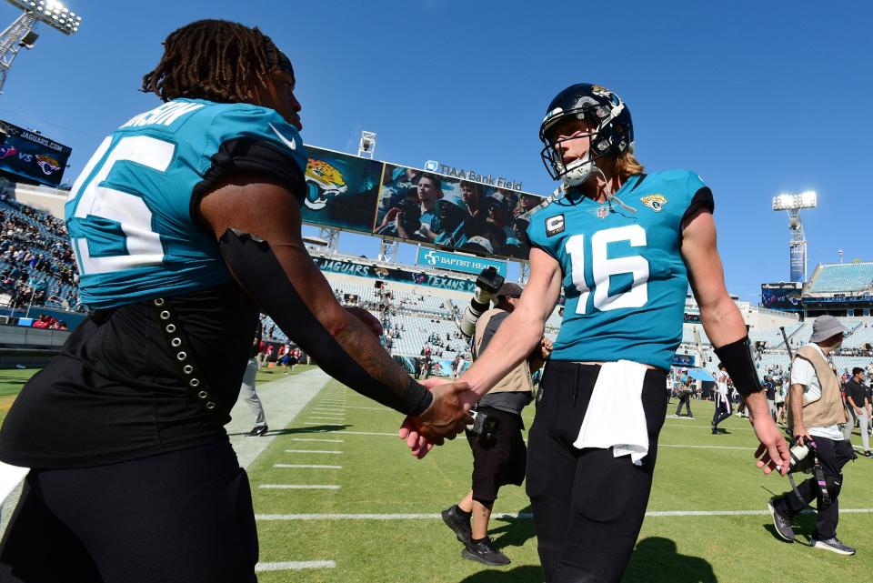 Jacksonville Jaguars quarterback Trevor Lawrence (16) is greeted by teammate running back James Robinson (25) as Lawrence left the field following Sunday's loss to the Titans. The Jacksonville Jaguars hosted the Houston Texans at TIAA Bank Field in Jacksonville, FL Sunday, October 9, 2022. The Jaguars fell to the Texans with a final score of 13 to 6. [Bob Self/Florida Times-Union]