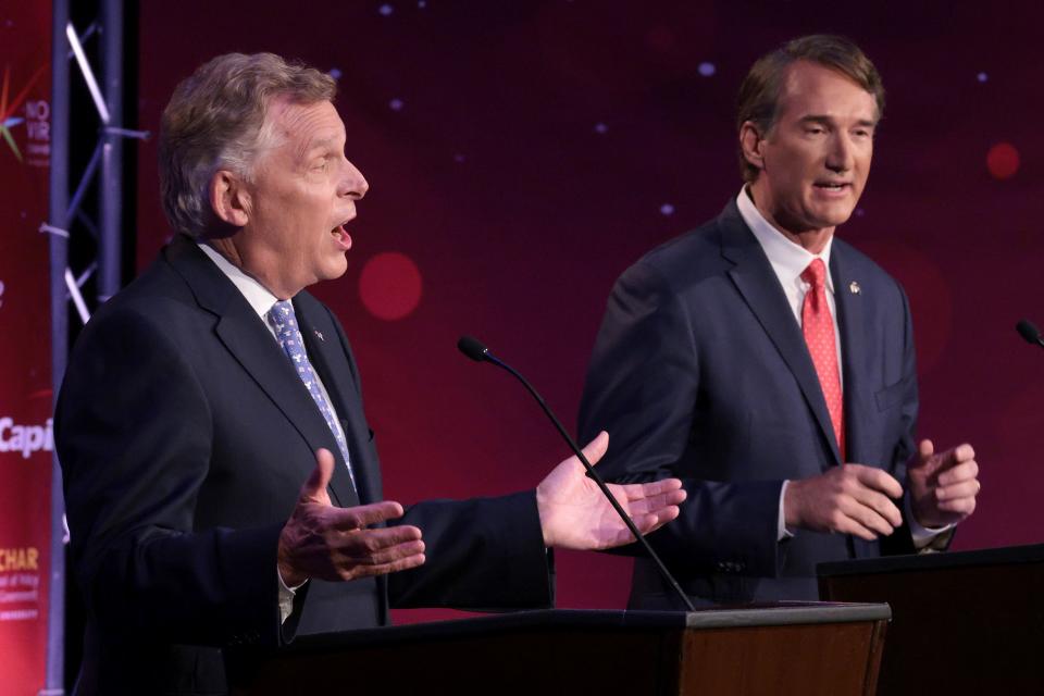 Former Virginia Gov. Terry McAuliffe (L) and Republican gubernatorial candidate Glenn Youngkin participate in a debate at Northern Virginia Community College, in Alexandria, Va., Tuesday, Sept. 28, 2021.