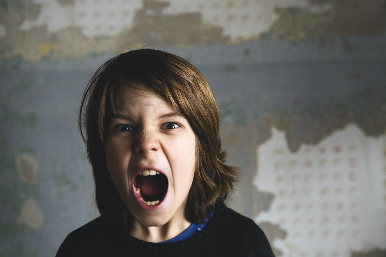 Boy screaming and looking at camera