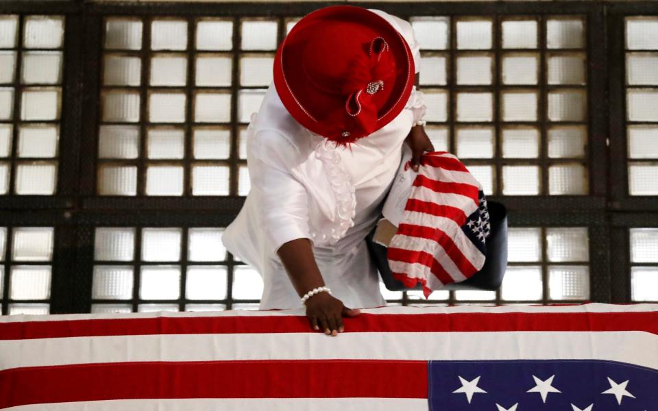 Ga Breedlove pauses by the casket of Rep. John Lewis lying in repose at the state capital - AP