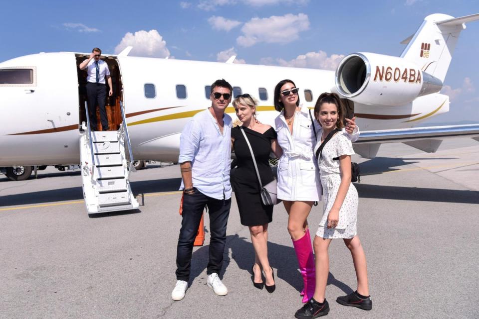 Dua Lipa flanked by her mother Anesa Lipa (second left), her father Dukagjin Lipa (left), and her sister Rina Lipa (right) as they pose for a picture upon her arrival at the airport in Pristina in 2018 (Armend Nimani / AFP / Getty Images)