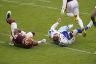 Dallas Cowboys quarterback Andy Dalton's (14) helmet comes off after getting hit by Washington Football Team inside linebacker Jon Bostic (53) in the second half of an NFL football game, Sunday, Oct. 25, 2020, in Landover, Md. Dalton left the field after this hit and Bostic was ejected from the game. (AP Photo/Patrick Semansky)