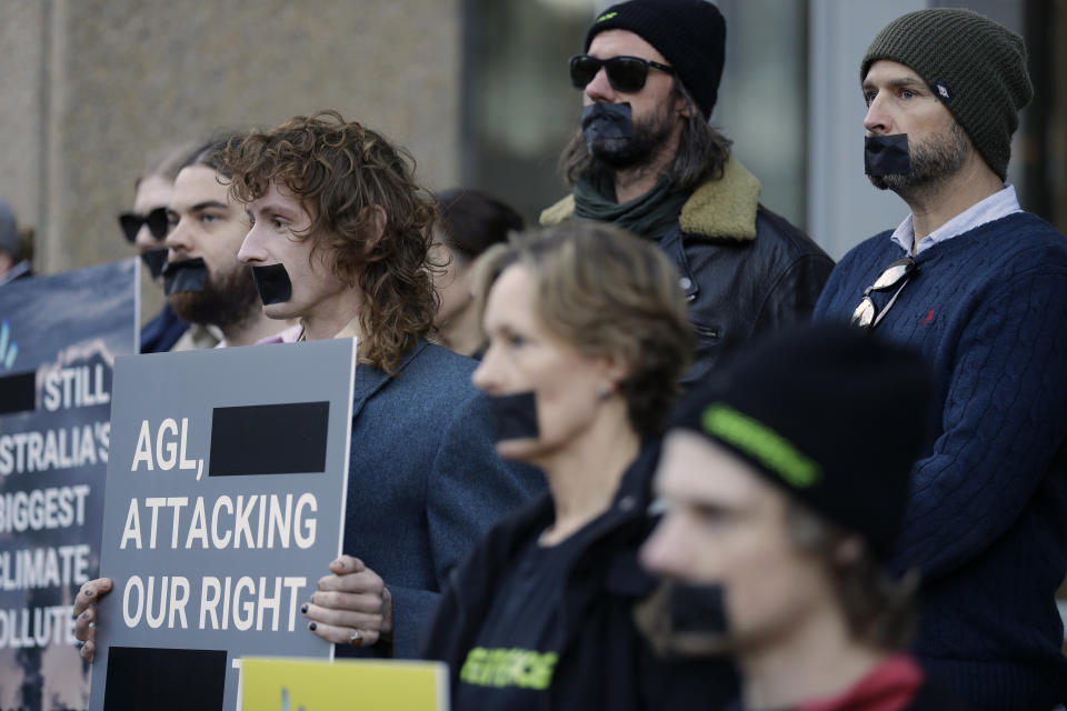 Greenpeace supporters demonstrate outside the Federal Court in Sydney, Wednesday, June 2, 2021. Australia's largest electricity generator AGL Energy is taking Greenpeace to court alleging breaches of copyright and trademark laws in the environmental charity's campaign that describes AGL as the nation's "biggest climate polluter." (AP Photo/Rick Rycroft)