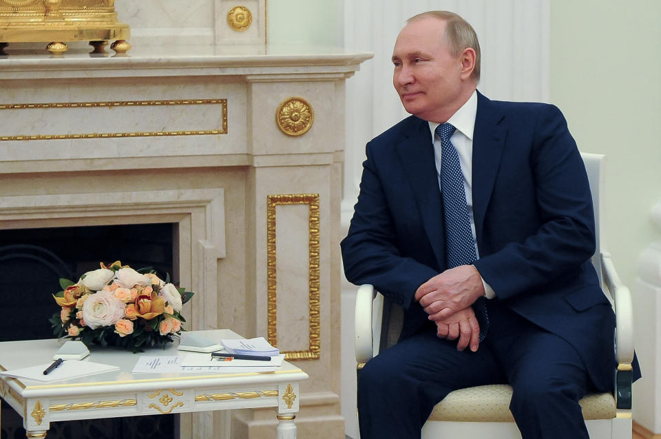 Russian President Vladimir Putin listens to Brazil's President Jair Bolsonaro during their meeting in the Kremlin in Moscow, Russia, Wednesday, Feb. 16, 2022. (Mikhail Klimentyev, Sputnik, Kremlin Pool Photo via AP)