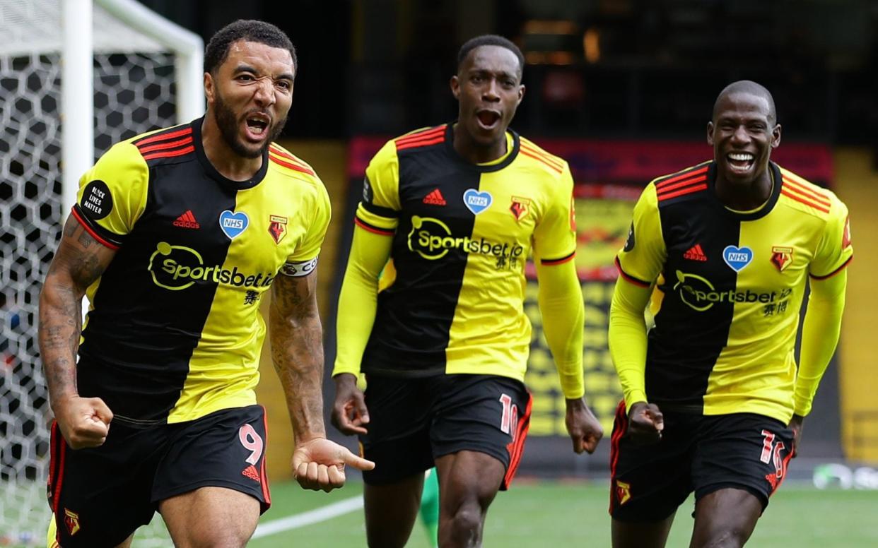 Watford's English striker Troy Deeney (L) celebrates after he scores takes a penalty and scores his team's second goal past Newcastle United's Slovakian goalkeeper Martin Dubravka - AFP