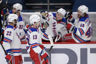 New York Rangers left wing Alexis Lafrenière (13) celebrates his goal with defenseman Anthony Bitetto (22), right wing Julien Gauthier (12) and left wing Brendan Lemieux (48) during the second period of an NHL hockey game against the Washington Capitals, Saturday, Feb. 20, 2021, in Washington. (AP Photo/Nick Wass)