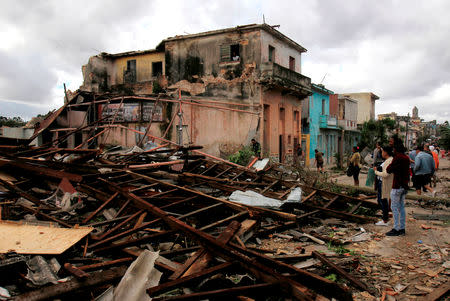 People look on to debris after a tornado ripped through a neighbourhood in Havana, Cuba January 28, 2019. REUTERS/Stringer