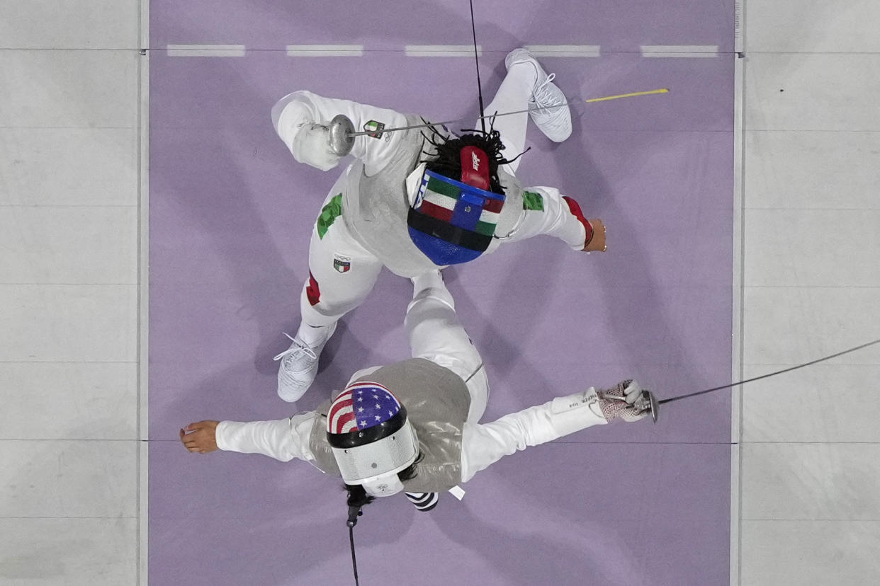 Seen from overhead, U.S. fencer Lee Kiefer competes with Italy's Alice Volpi, top, in the women's individual foil semifinal match. 