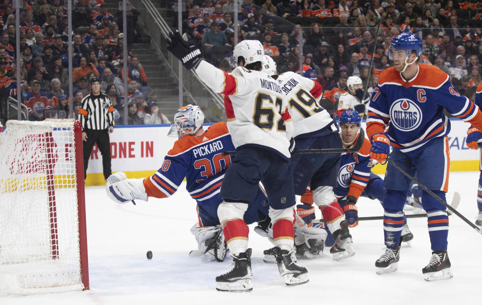 Florida Panthers' Brandon Montour (62) celebrates a goal on Edmonton Oilers goalie Calvin Pickard (30) during the first period of an NHL hockey match in Edmonton, Alberta, on Saturday, Dec. 16, 2023. (Jason Franson/The Canadian Press via AP)