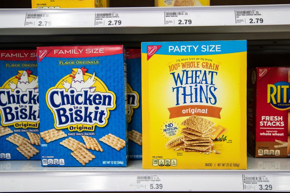 Many shoppers are experiencing higher food prices while receiving less product from popular food brands, something industry leaders call "shrinkflation." Shrinkflation is the downsizing of a product while keeping its sticker price the same and it is happening to popular brands found in grocery stores across the country. A 20 ounce of party size of Wheat Thins and a 12-ounce pack of Chicken in a Biskit at the Meijer in Ypsilanti on March 31, 2022.