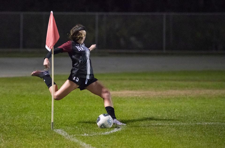 Katie Kauth (15) boots a corner kick leading to a Hunter Wallace (21) goal and a 2-1 Raiders lead in the 25th minute during the Pace vs Navarre girls soccer game at Navarre High School on Tuesday, Jan. 11, 2022.