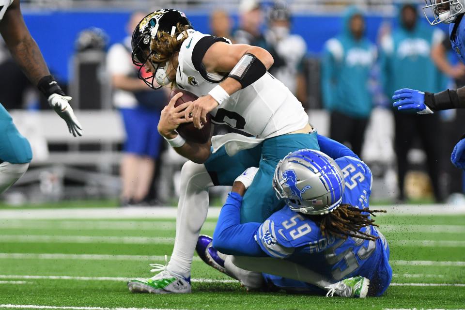 Jacksonville Jaguars quarterback Trevor Lawrence (16) is sacked by Detroit Lions linebacker James Houston (59) on Sunday, Dec. 4, 2022 in the second quarter at Ford Field in Detroit, Michigan.