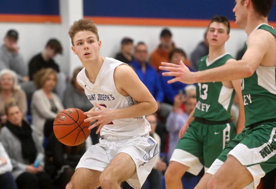 Saint Joseph’s Ben Eby dribbles around Juniata Valley defenders during the game on Wednesday, Feb. 1, 2023.