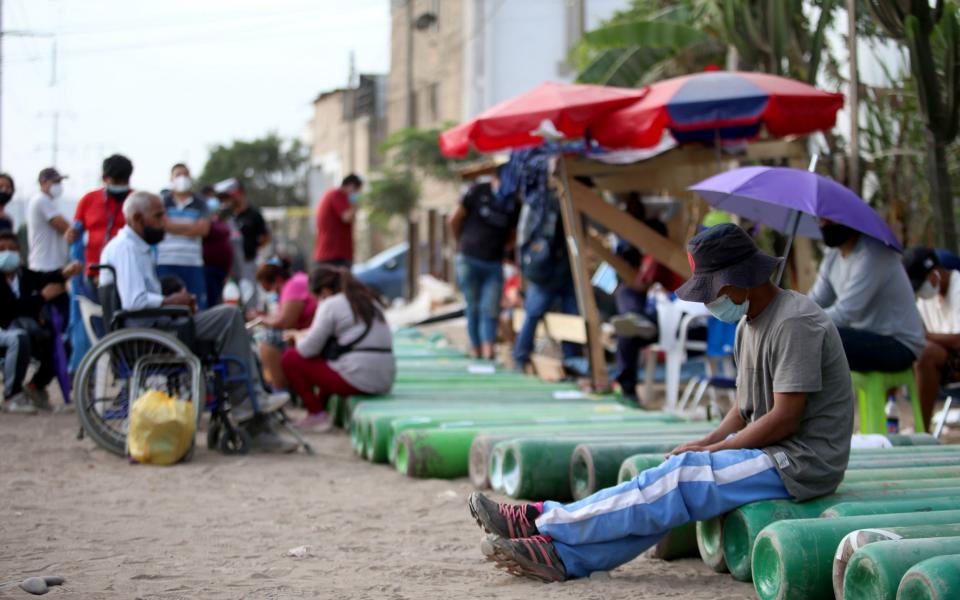 Medical Oxygen to treat COVID-19 patients is scarce and Peru is now importing form Chile to satisfy demand. Relatives make lines overnight to have their cylinders refilled. - Raul Sifuentes/Getty Images