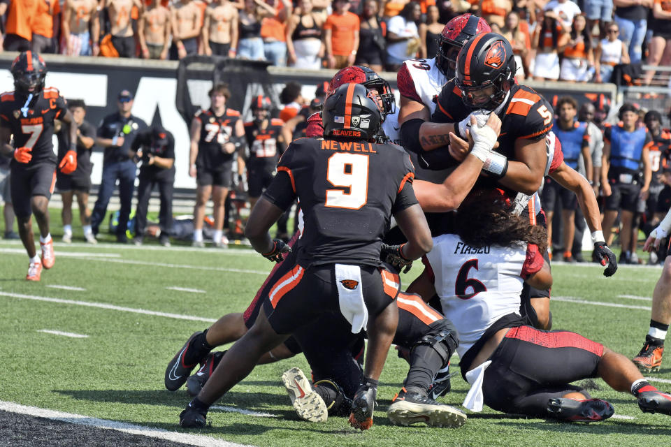 San Diego State defensive lineman Tupu Alualu (99) and linebacker Zyrus Fiaseu (6) stop Oregon State quarterback DJ Uiagalelei (5) on a two-point conversion during the first half of an NCAA college football game Saturday, Sept. 16, 2023, in Corvallis, Ore. (AP Photo/Mark Ylen)