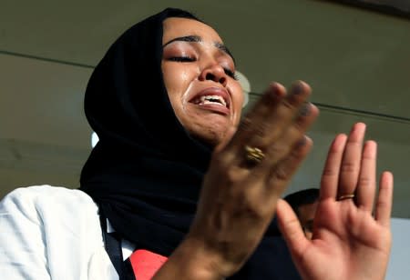 A Sudanese woman reacts during celebration following Sudan's ruling military council and a coalition of opposition and protest groups reached an agreement to share power during a transition period leading to elections, in Khartoum