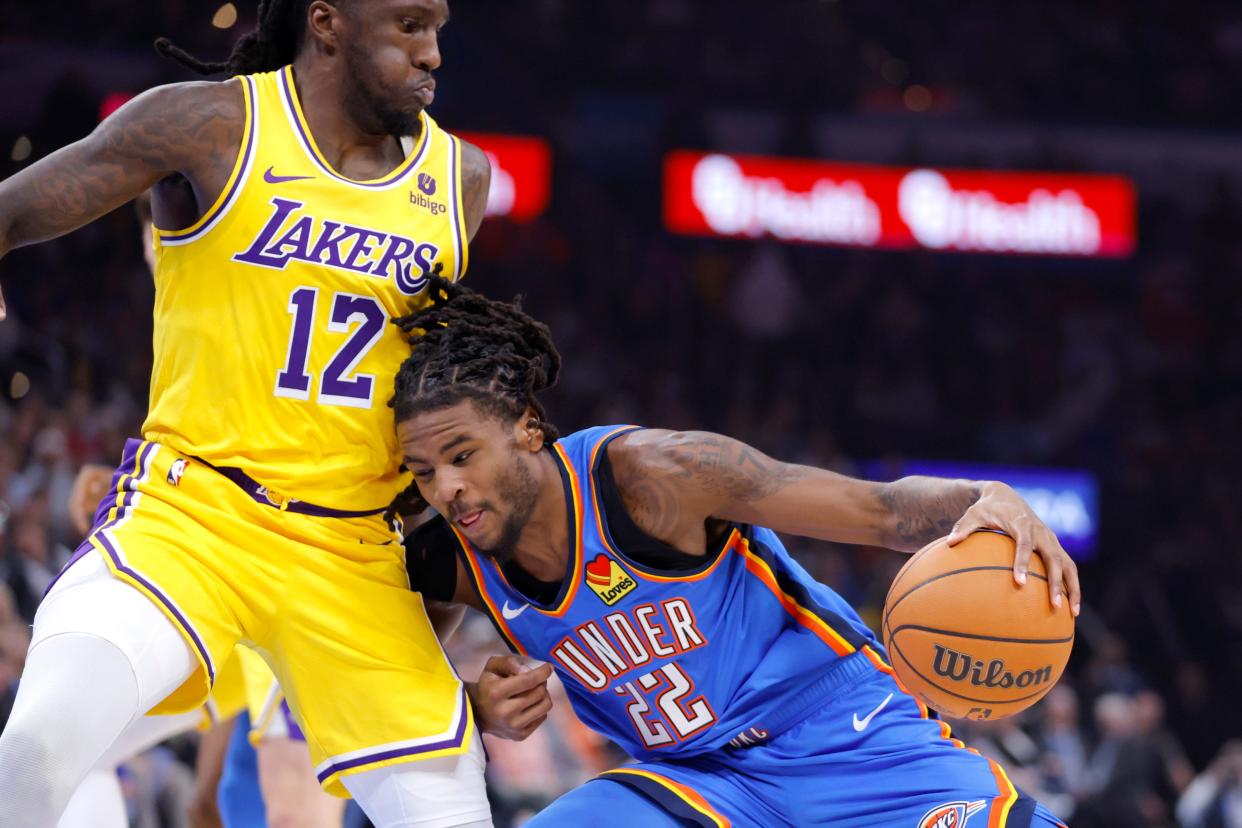 Oklahoma City Thunder guard Cason Wallace (22) tries to get past Los Angeles Lakers forward Taurean Prince (12) during an NBA basketball game between the Oklahoma City Thunder and the Los Angeles Lakers at Paycom Center in Oklahoma City, Thursday, Nov. 30, 2023.